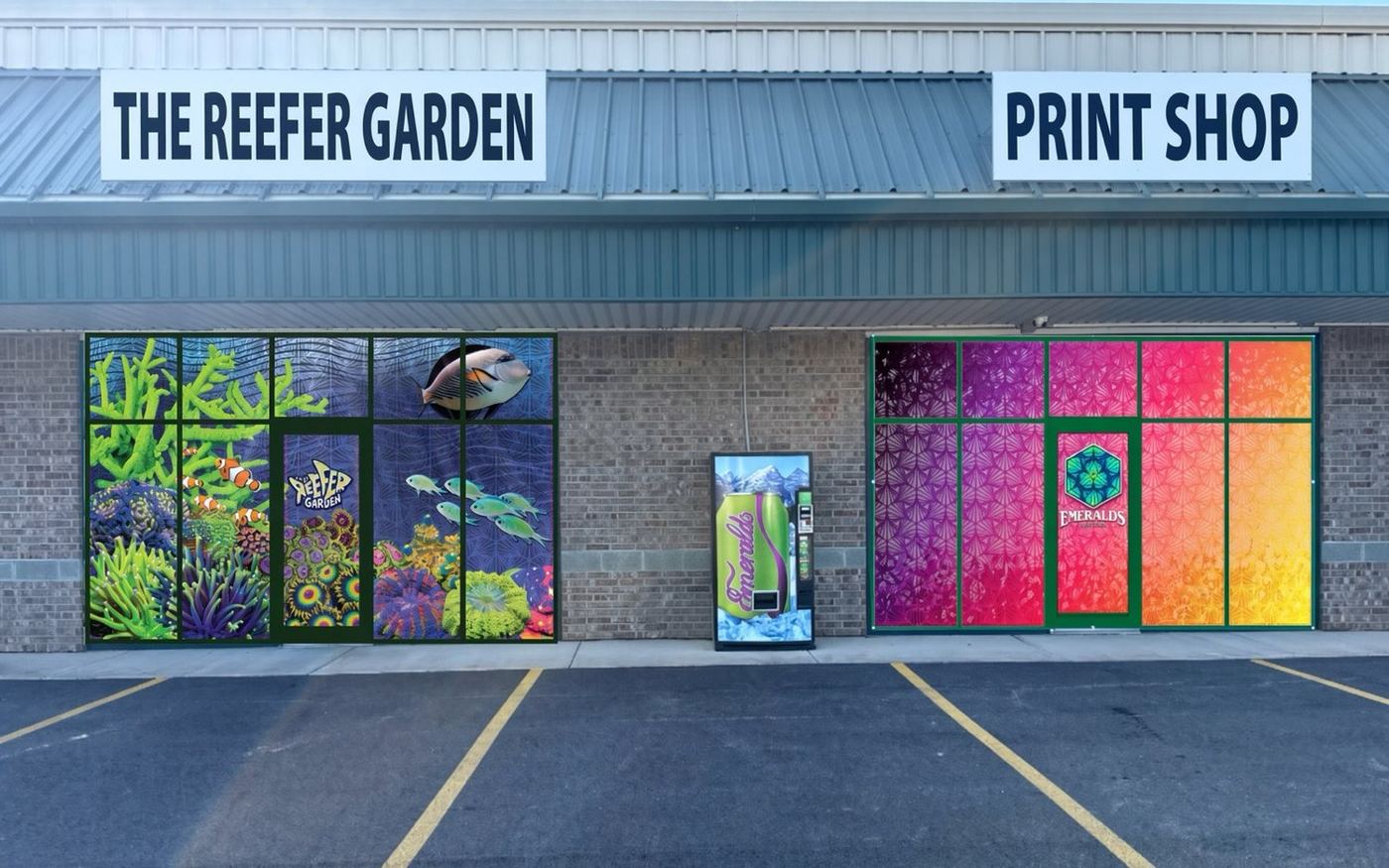 Emerald's Print Shop next to The Reefer Garden — PRINT SHOP sign over magenta window wraps