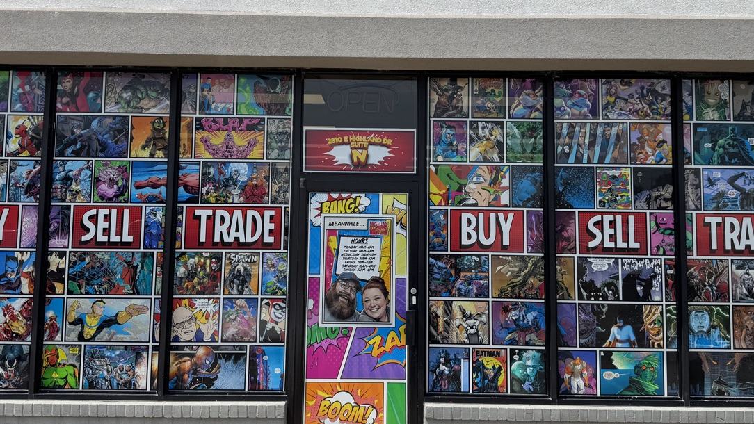 Comic shop storefront with BUY SELL TRADE perforated window vinyl