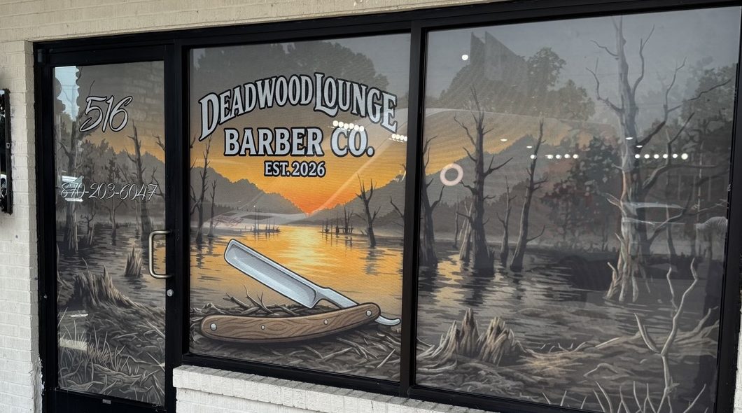 Deadwood Lounge Barber Co. storefront with swamp-sunset window vinyl